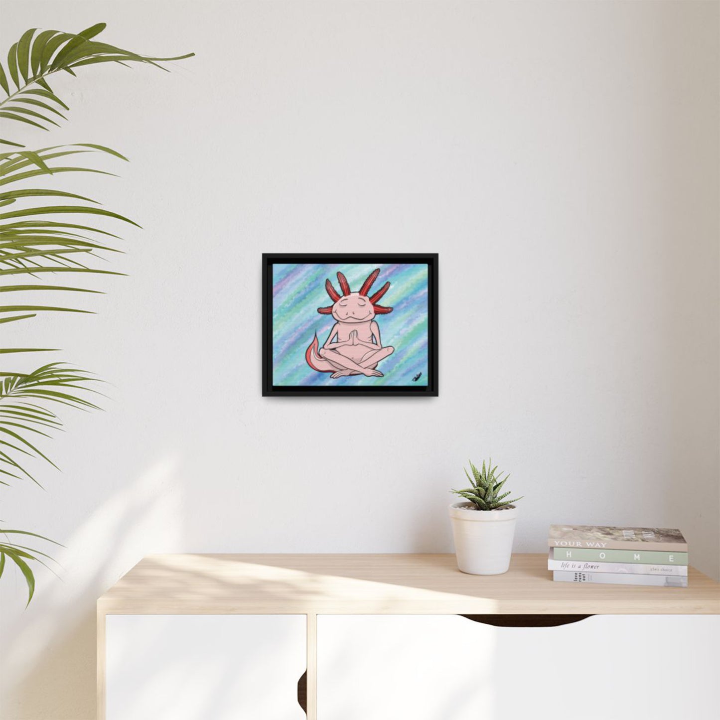 Bioluminescent teal axolotl art in a black floating frame for home office wellness.